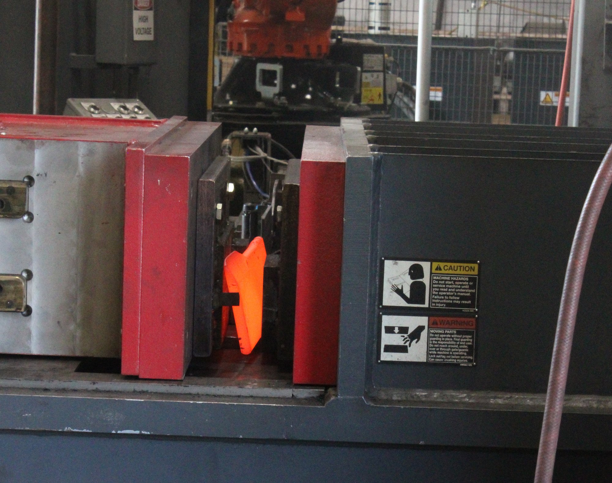 Glowing hot part in the forging press