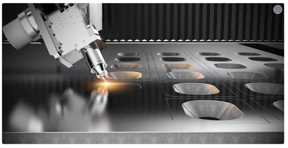 Fiber laser cutting head at work on steel plate